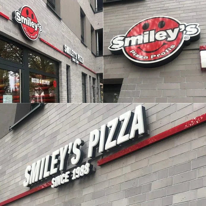 Leuchtreklame Smileys Pizza an grauer Fassade in Hamburg - Leuchtkasten Rund - Einzelbuchstabenanlage Leuchtreklame Smileys Pizza an grauer Fassade in Hamburg - Leuchtkasten Rund - Einzelbuchstabenanlage
